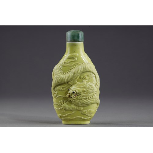 Snuff bottle porcelain enamelled yellow molded and sculpted with a dragon